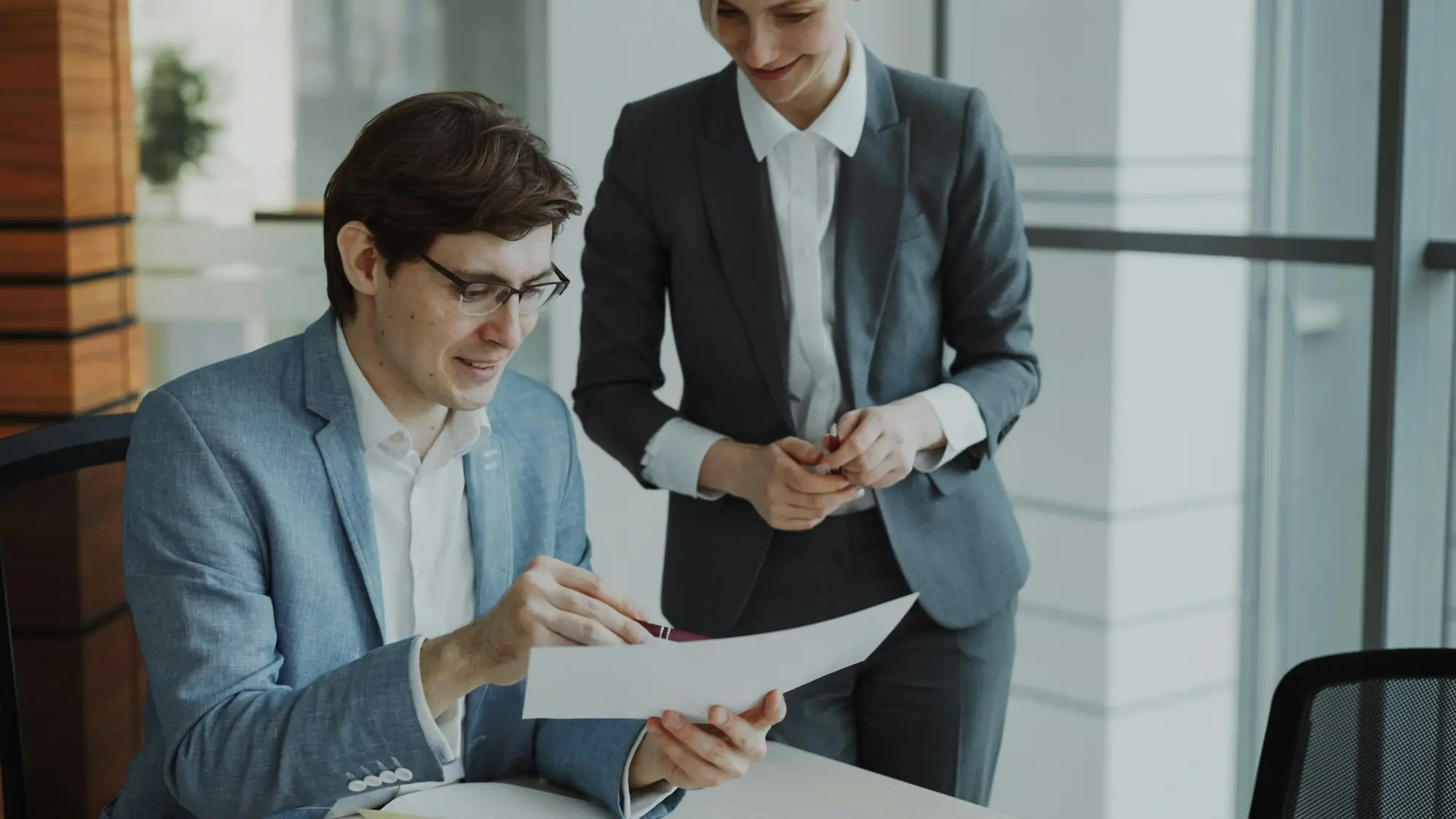 Business owner and adviser reviewing documents together