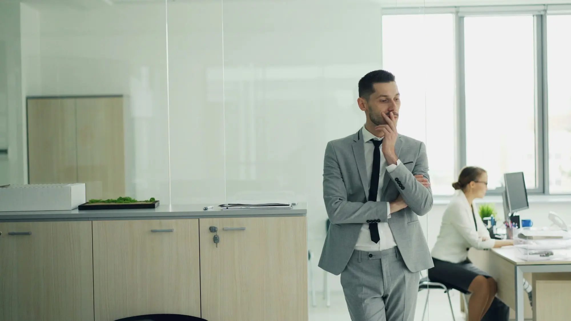 Business owner thinking carefully at his desk in an office