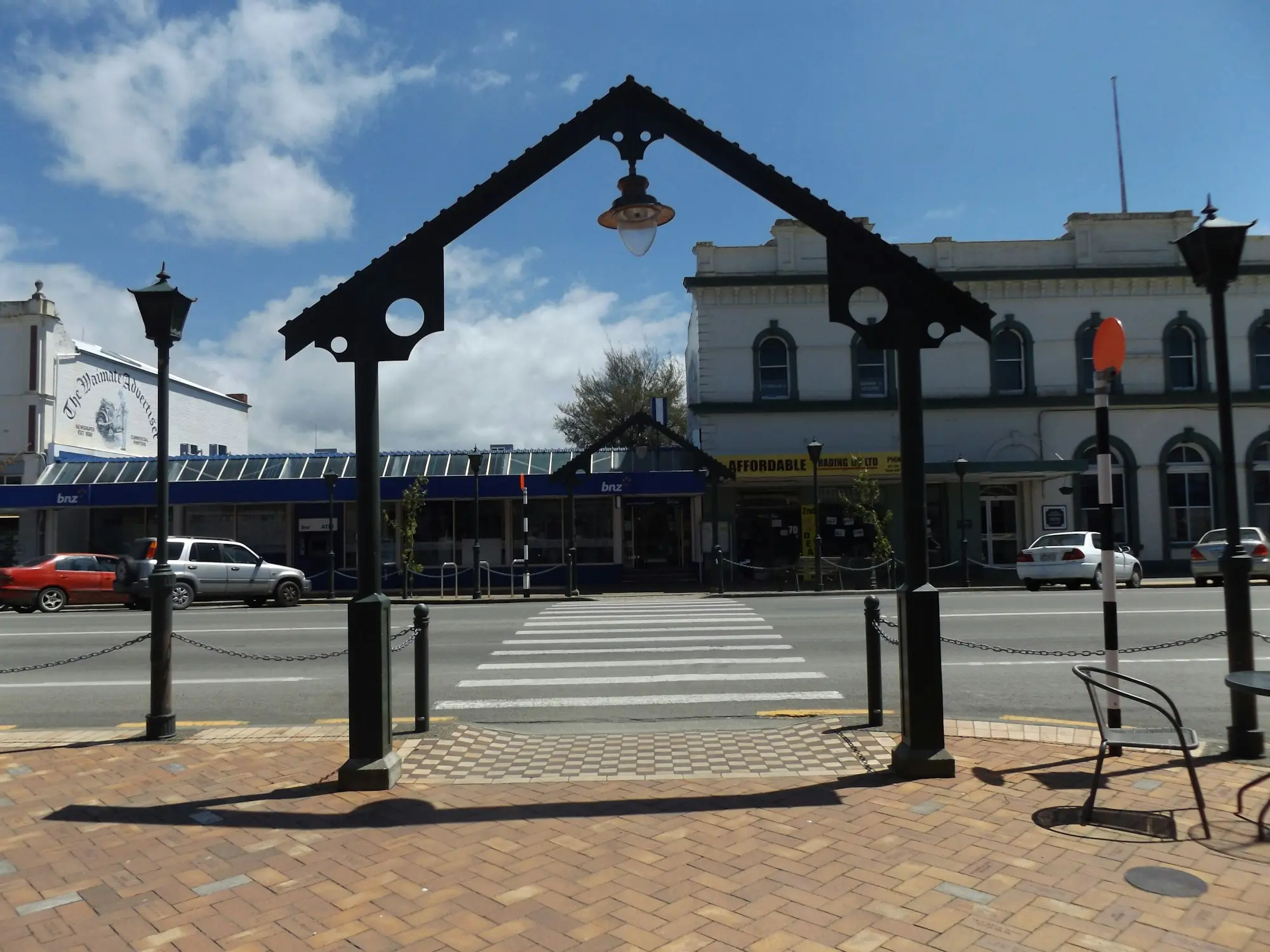 Shops and a pedestrian crossing on a town main street